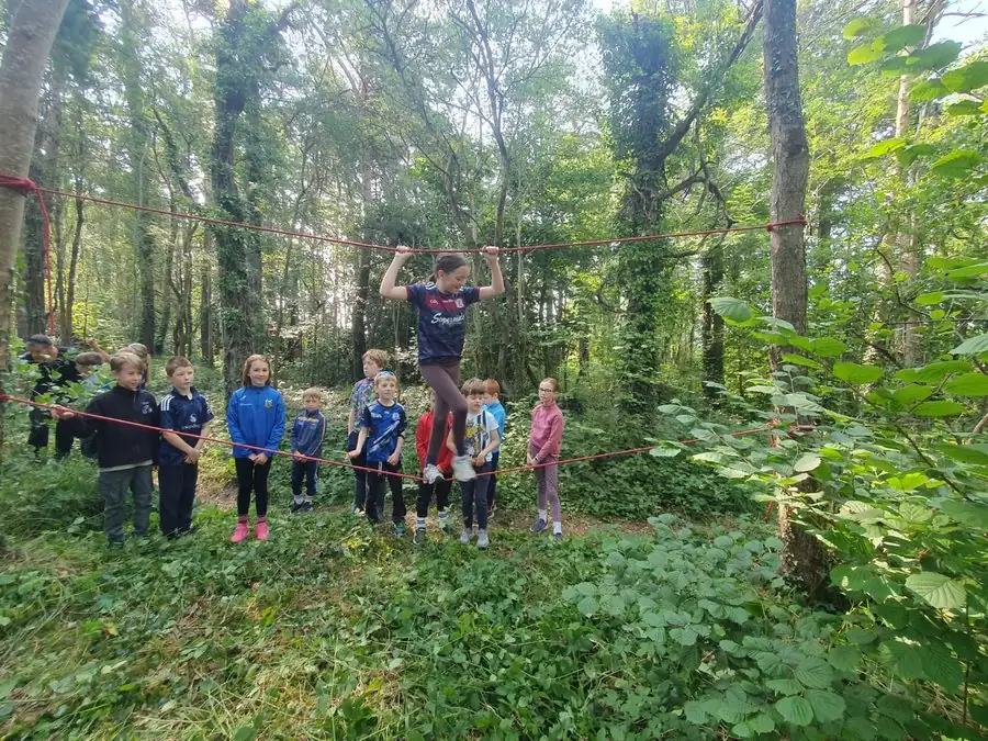 Children taking part in a Forest School rope challenge
